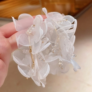 Handmade white mesh flower earrings with gold bead accents and transparent crystals