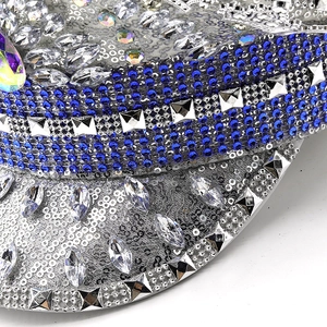 Close-up of sparkling silver sequins and blue rhinestone details on a flat-top military hat