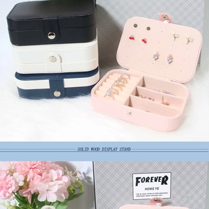 Detail of travel jewelry box showing ring slots and earring panel in multiple colors