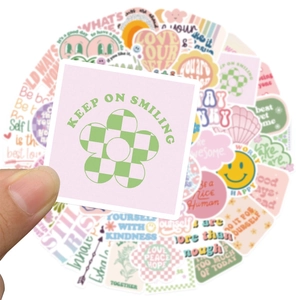 Macro shot of a pink sticker with flower pattern and Keep On Smiling text