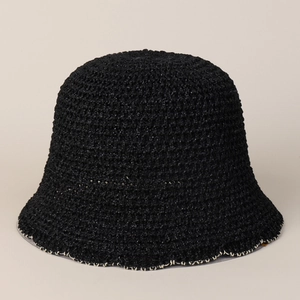 Detailed view of black crochet bucket hat texture with contrast beige stitching on wavy brim