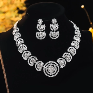 Luxurious bridal jewelry set featuring sparkling rhinestone necklace and earrings on a bust