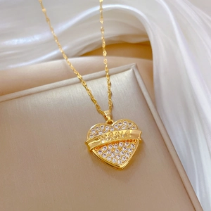 Luxurious gold heart pendant necklace with sparkling gems and MAMA engraving on silk cloth
