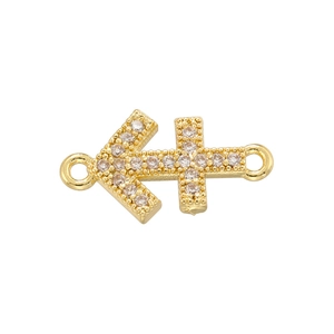 Macro shot of gold Sagittarius zodiac pendant with cubic zirconia and dual connectors