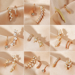 9-piece gold alloy earring set with sparkling cubic zirconia stars and leaves