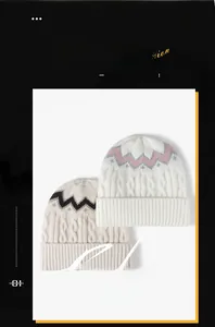 Detail of cable knit beanies with wave patterns and thick folded cuffs for winter warmth