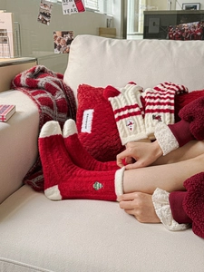 Detailed embroidery of Christmas tree and reindeer on thick festive thermal socks