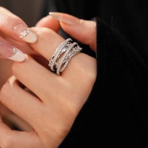 Close-up of luxury crisscross ring with multi-layer zircon stones and silver plating