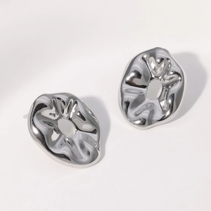 Polished silver irregular metal stud earrings with organic texture and cutout detail