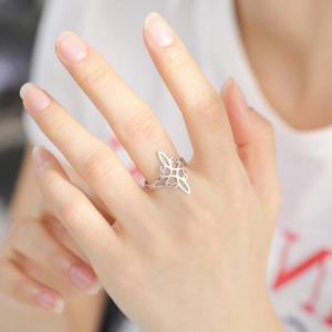 Minimalist stainless steel open ring featuring a geometric Celtic knot hollow pattern