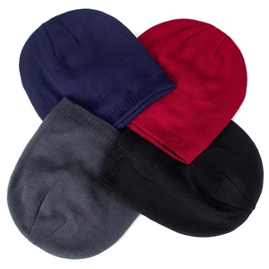 Flat lay detail showing four winter knit beanies in navy, burgundy, grey, and black
