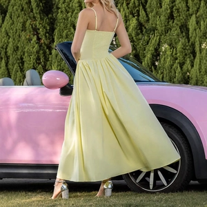 Back view of a yellow satin maxi dress with ruffled hem and smocked back detailing