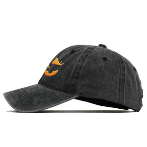 Detail of Jack-o'-lantern embroidery on a vintage washed black cotton baseball cap