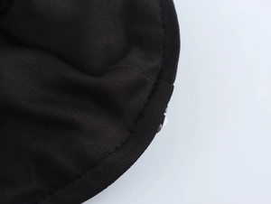 Close-up of black sequin party dress showing knit texture and premium stitching details
