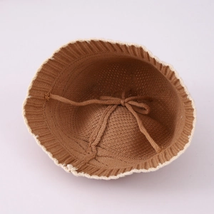 Brown knit bucket hat for kids with white wavy trim and adjustable inner drawstring