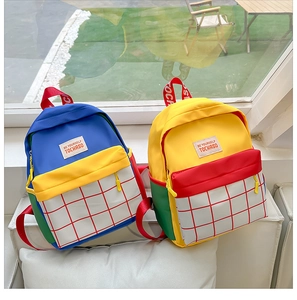 Detailed view of colorful canvas kids backpacks with plaid front pockets and top handles