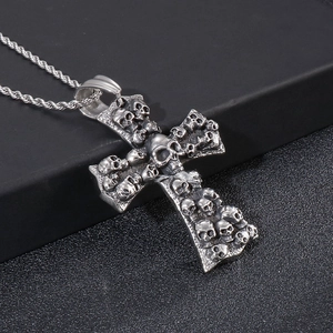 Macro detail of gothic skull cross pendant in silver stainless steel on twisted chain
