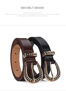Detail of vintage horseshoe buckle in gold on high-quality black and brown leather belts
