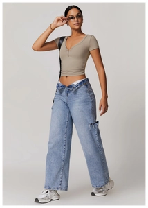Detail of khaki Henley short sleeve yoga top with buttoned V-neckline and cropped fit