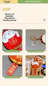 Detailed macro view of red lucky cat keychain with gold metal hook and embossed characters