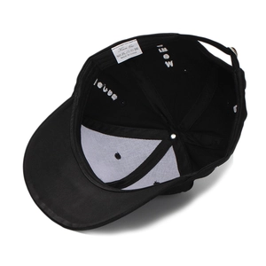 Internal view of black cotton baseball cap showing wash label and inner stitching details