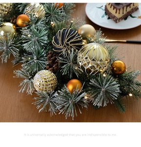 Close-up of 135cm Christmas garland with golden ornaments, pine cones, and LED lights