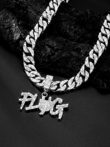 Macro detail of silver Cuban link chain with iced-out FLAG letter pendant for men