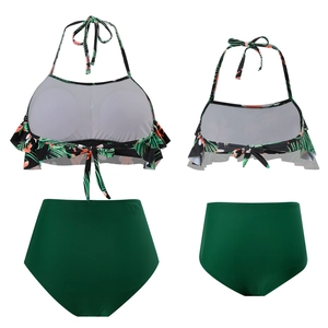 Detail of matching mother and daughter two-piece swimsuits with tropical floral prints