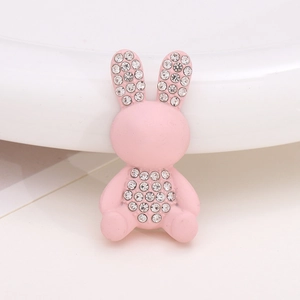 Detail view of a pink bunny accessory with sparkling rhinestones for shoes and jewelry