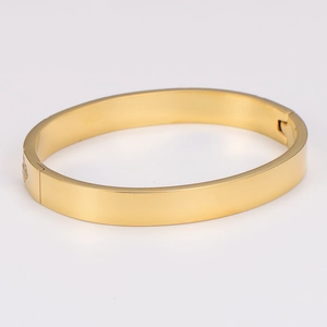 Detailed top view of a gold-plated stainless steel bangle with polished mirror finish