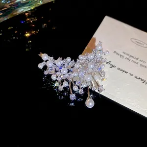 Elegant French vintage butterfly brooch with white pearls and sparkling zircons on a dark base