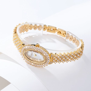Detailed view of luxury gold oval watch featuring diamond-encrusted bezel and metallic strap