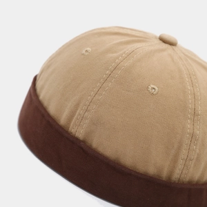 Detailed view of khaki and brown cotton stitching on a minimalist miki docker hat