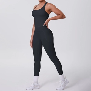 Detail of high-waist black yoga leggings with functional side pockets and seamless fit