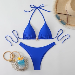 Royal blue bikini set featuring a gold starfish charm and stylish beach accessories