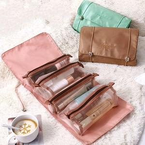 Macro view of multi-compartment travel toiletry bag with four transparent zipper pockets