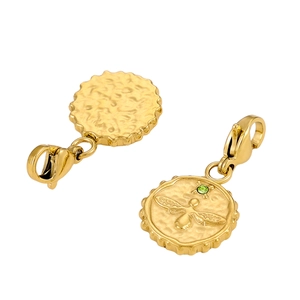 Detailed macro view of a gold-plated bee relief pendant with a green gemstone inlay
