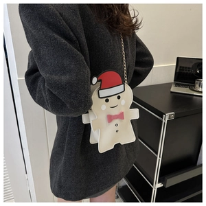 Detailed view of gingerbread man crossbody bag on model showing size and gold chain strap