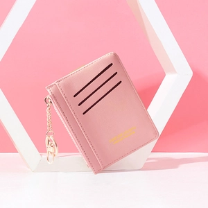 Pink PU leather mini wallet with zipper closure and gold keychain on white pedestal