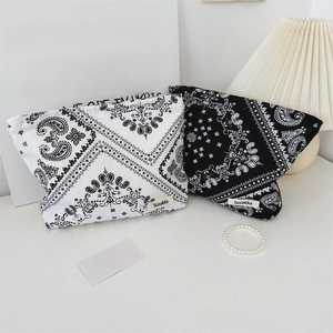 Floral paisley canvas cosmetic bags in black and white shown in a lifestyle setting