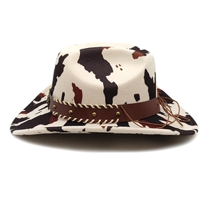 Detail of cow print western cowboy hat with studded leather band and fringe trim