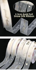 Macro detail of 2.5cm sheer chiffon ribbon with gold foil LOVE text and star heart patterns