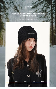 Close-up of black ribbed knit beanie with Unique and Casual brand patch detail