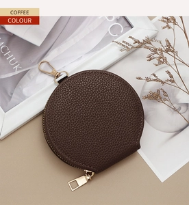 Macro detail of coffee brown litchi grain leather coin purse with golden zipper and hook