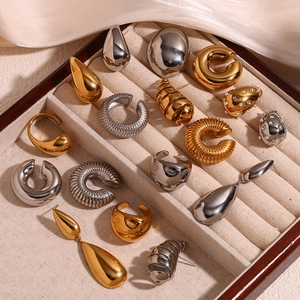 Detail showing assorted gold and silver drop earrings with polished finish and pearls