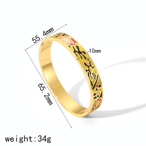Detail view of 18k gold plated titanium steel bangle with colorful enamel floral pattern