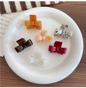 Set of 6 colorful acetate bow hair clips in marble and tortoiseshell patterns