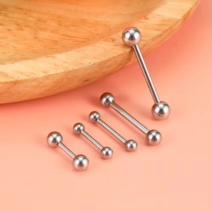 Detailed macro view of silver stainless steel barbell tongue rings in multiple bar lengths