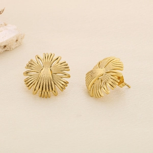 Macro shot of geometric gold flower stud earrings with a textured grainy finish