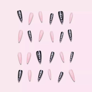 Gothic stiletto press-on nails featuring black and pink bones for Halloween